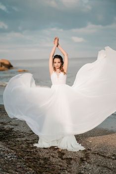 bride on the shore of the black sea in the sunset light