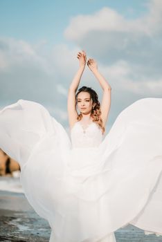 bride on the shore of the black sea in the sunset light