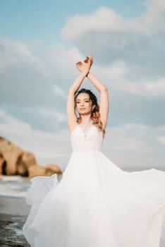 bride on the shore of the black sea in the sunset light