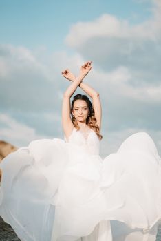 bride on the shore of the black sea in the sunset light