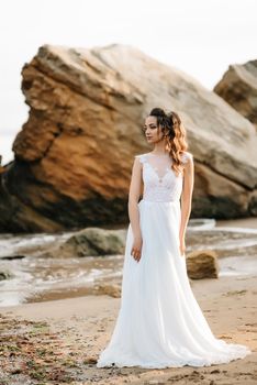 bride on the shore of the black sea in the sunset light