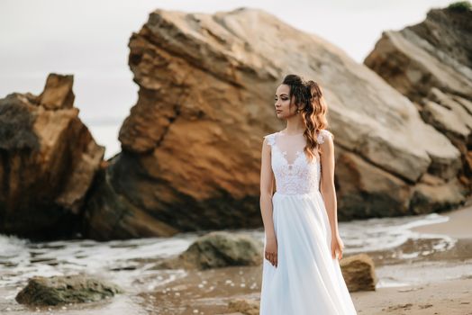 bride on the shore of the black sea in the sunset light