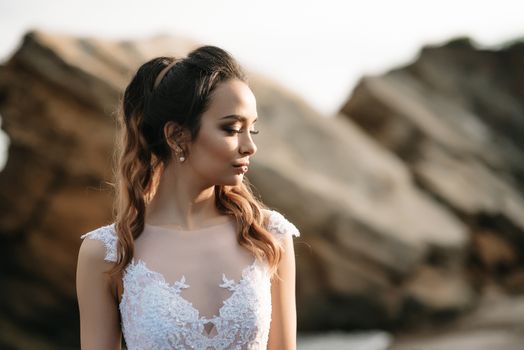 bride on the shore of the black sea in the sunset light