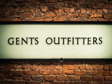 Old Fashioned Retro Vintage Gents Outfitters Sign On A Red Brick Wall In London