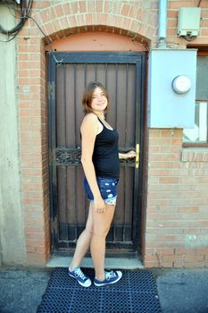 Female beauty expressions against a wall outside.