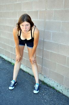 Female beauty expressions against a wall outside.