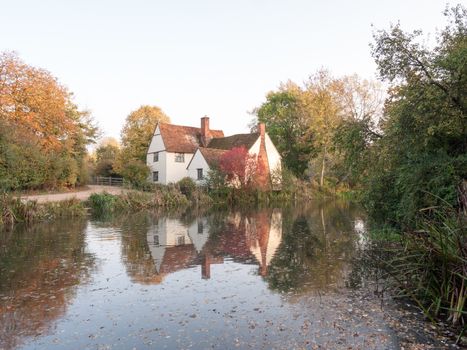 willy lotts cottage at flatford mill in suffolk in autumn reflections in lake; suffolk; england; uk