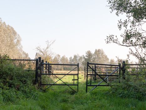 set of black farm field country gates empty and open; essex; england; uk