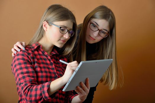 two young teenage girls with a tablet