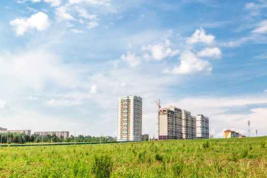 Construction of new houses near a glade in sunny day