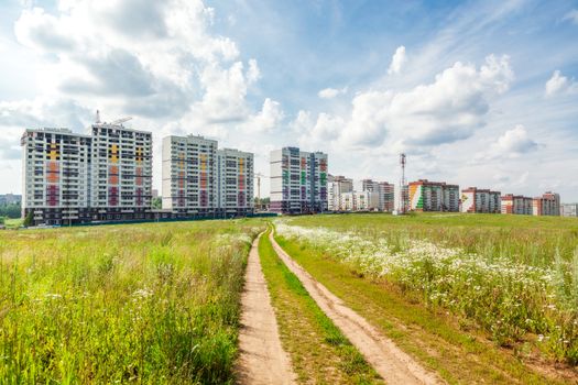 Construction of new houses near a glade in sunny day