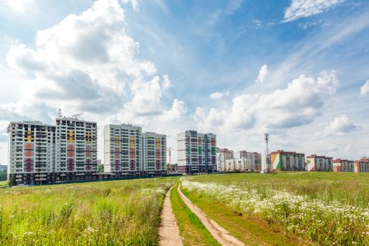 Construction of new houses near a glade in sunny day