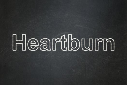 Medicine concept: text Heartburn on Black chalkboard background