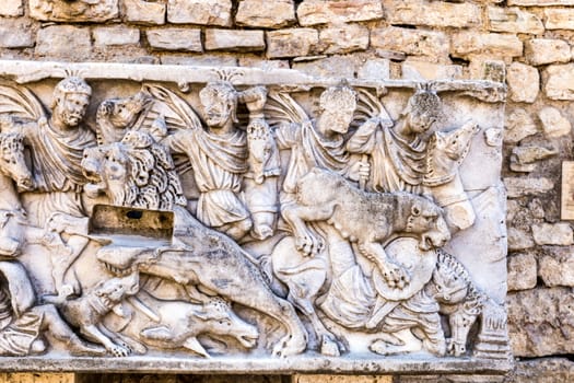 Roman bas-relief in the ancient stone walls