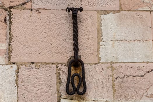 medieval stone wall with ancient ironwork