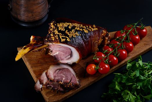 Roast pork knuckle and ingredients close-up on a slate board. Traditional european cuisine