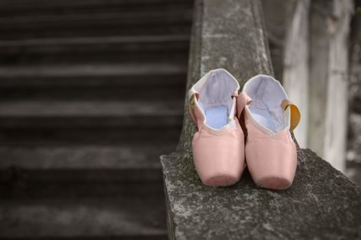 Pink pointe shoes for a classical ballerina, close-up on concrete