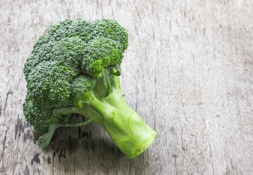 Closeup fresh broccoli on wooden background, raw food for cooking
