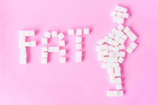 FAT text and fat man shape with sugar cubes on sweet pink background, food and healthy concept