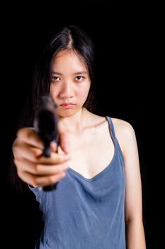 Teenage Asian American girl pointing handgun