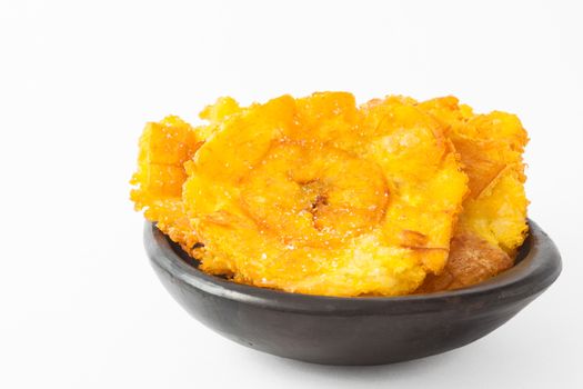 Plantain patacones on black ceramic dish