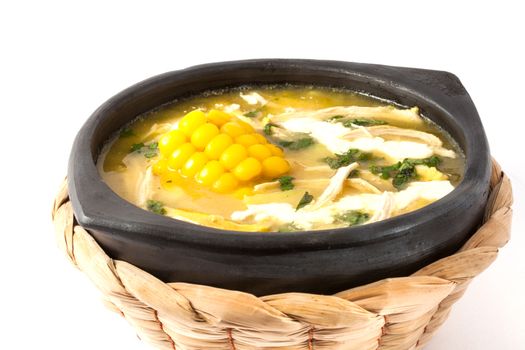 Traditional Colombian ajiaco served on black ceramic dish