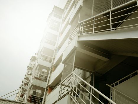 fire escape stairs with sunlight of outside buildings