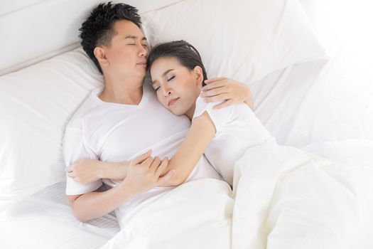 Young loving couple in the bed. Modern lifestyle concept