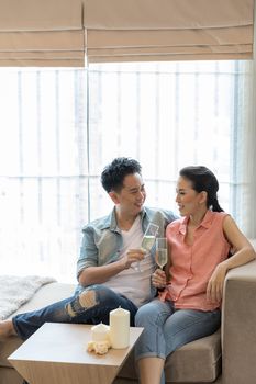 Young Couples celebrate together with wine  in bedroom of contemporary house for modern lifestyle concept
