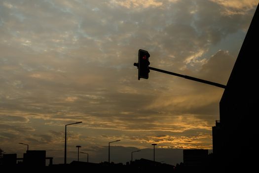 Sunset and a traffic light in the city