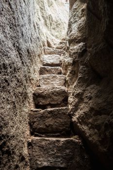 Narrow staircase of stone in rock