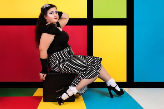 View of pinup vintage girl next to a colorful pop art backdrop.