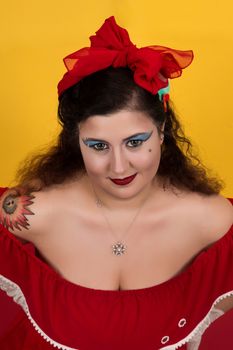 View of pinup vintage girl next to a colorful red and yellow background.