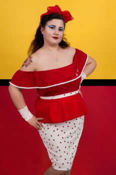View of pinup vintage girl next to a colorful red and yellow background.