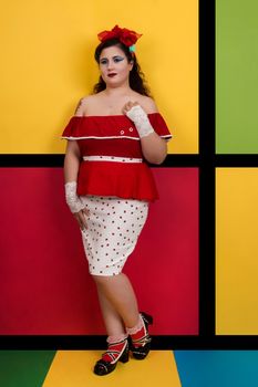 View of pinup vintage girl next to a colorful red and yellow background.