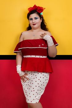 View of pinup vintage girl next to a colorful red and yellow background.