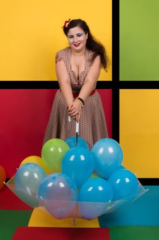 Pinup girl with balloons on a umbrella.