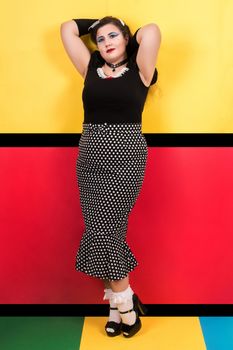 View of pinup vintage girl next to a colorful pop art backdrop.