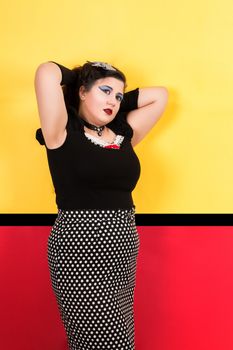 View of pinup vintage girl next to a colorful pop art backdrop.