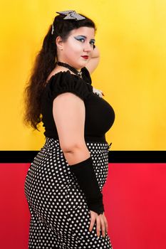 View of pinup vintage girl next to a colorful pop art backdrop.