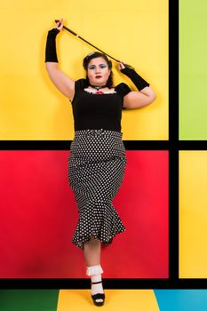 View of pinup vintage girl next to a colorful pop art backdrop.