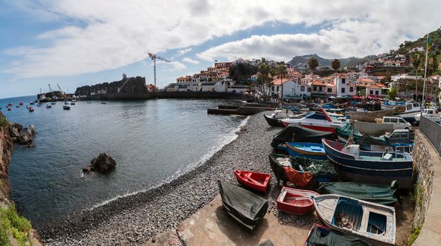 Traditional fishing boats on the shoreline of Camara de Lobos village, Madeira.