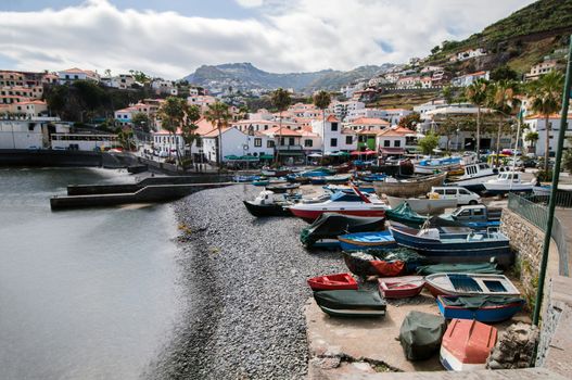 Traditional fishing boats on the shoreline of Camara de Lobos village, Madeira.