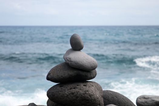 Zen style balanced stones on Ribeira da Janela beach, Madeira island, Portugal.