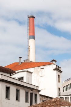 View of a tall factory red chimney in Funchal, Madeira.