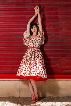 Woman posing with a vintage style retro floral clothing.