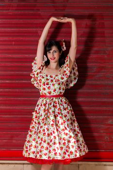 Woman posing with a vintage style retro floral clothing.