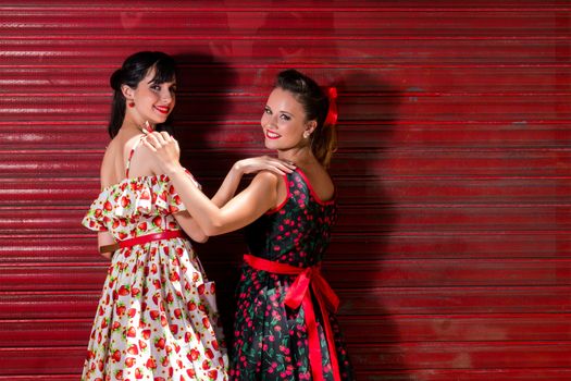 Women posing with a vintage style retro floral clothing.