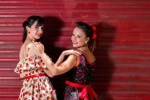 Women posing with a vintage style retro floral clothing.