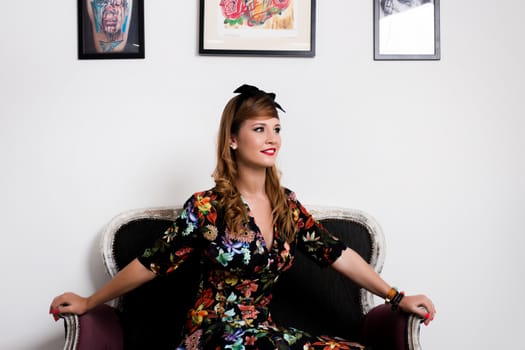 Woman posing with a vintage style retro floral clothing.